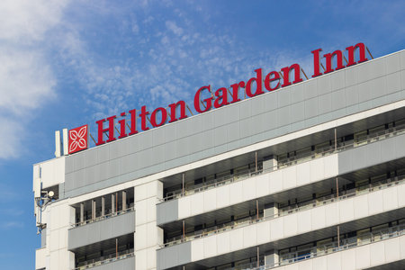 Krasnoyarsk, Russia - October 16, 2022: Hilton Garden Inn hotel logo on facade. Hilton Garden Inn is an American chain of mid-priced, limited or focused service hotels owned by Hilton Worldwide.のeditorial素材