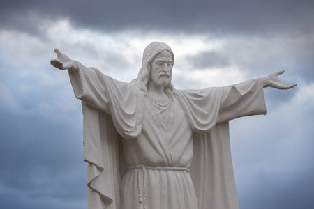 Krasnoyarsk, Russia - 28 October, 2022: Statue of Jesus Christ with open arms against gray cloudy skyのeditorial素材