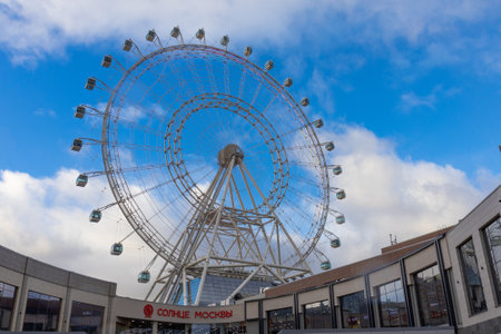 Moscow, Russia - 13 November, 2022: Sun of Moscow against blue sky. Sun of Moscow is a ferris wheel in VDNKh park, Moscow, Russiaのeditorial素材