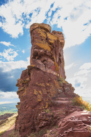 Strange geology rock formation against blue sky. Mountain range Sunduki in Khakassia, Russia. The butte is composed of red Devonian sandstoneの写真素材