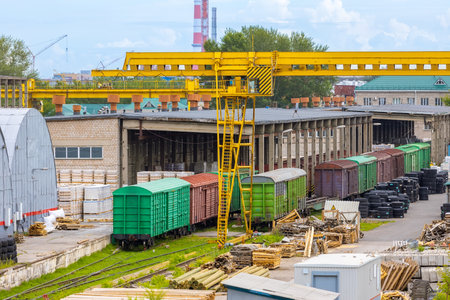 Railway warehouse at the dead end of the railway. Freight container trains on urban cargo terminal. Unloading goods from wagonsの写真素材