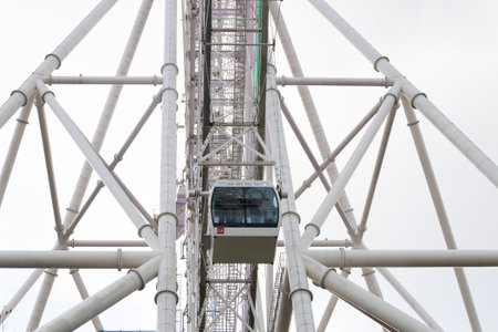 Moscow, Russia - 13 November, 2022: view on capsule cabin with people against giant steel frame structure of a ferris wheel Sun of Moscow. Modern ferris wheel in VDNKh park, Moscow, Russiaのeditorial素材