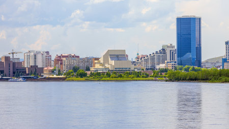 Krasnoyarsk, Russia - June 20, 2022: View of the Krasnoyarsk Regional Philharmonic and Museum Center Peace Squarel behind the Yenisei river. Strelka, the historic district with modern buildingsのeditorial素材