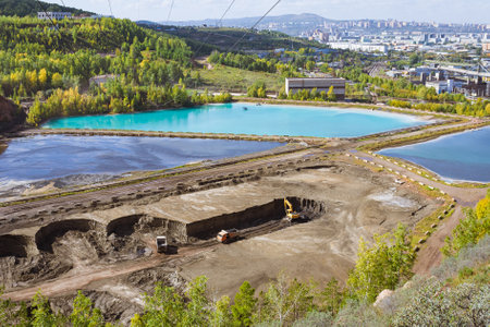 View on ash collectors of Thermal power plant in the quarry Uval Promarteli. Dirty water with bright...