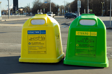 Moscow, Russia - November 14, 2022: Green and yellow litter bins for separate plastic and glass garbage in city.Recycling various types of recyclable trash.Caring for ecology.Environmental protectionのeditorial素材