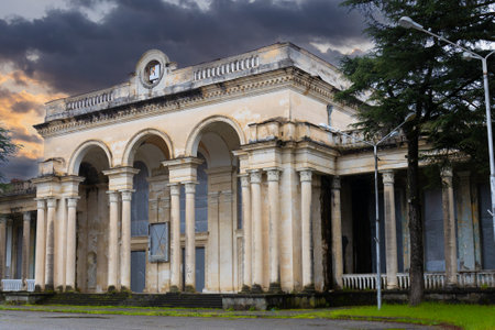 Gagra, Abkhazia, Georgia - 12 April, 2023: Facade of collapsing historic building of railway station building in Gagra, Abkhazia, Georgia. Soviet architecture. building restoration work.のeditorial素材