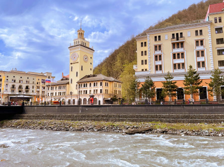 Sochi, Russia - 17 April, 2023: View on Rosa Khutor Town Hall. Stylized as the tower of the Sochi railway station. Rose Square with the Town Hall - famous square of Krasnaya Polyana and Estosadokのeditorial素材