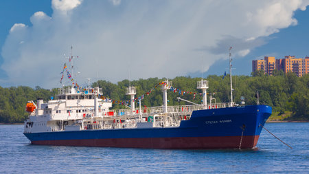 Krasnoyarsk, Russia - 30 June, 2023: Industrial ship Stepan Fomin decorating signal flags at Yenisey river. Oil tanker type LENANEFT for transportation of light oil products of classes I-III, gasolineのeditorial素材