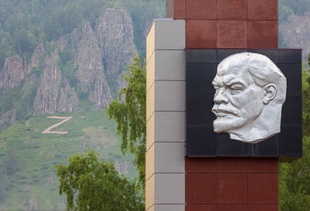 Divnogorsk, Russia - 17 June, 2023: Soviet portrait of Vladimir Lenin on stella and far letter Z on mountain slope. Lenin looks at the letter Z in the colors of the St. George ribbonのeditorial素材