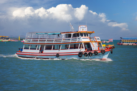 Pattaya, Thailand - December 21, 2023: View on empty tourist ferry at blue sea. Ferry daily take crowds of people to relax on the tropical island of Koh Larnのeditorial素材