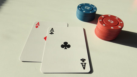 four aces and red chips on white background, shallow depth of field