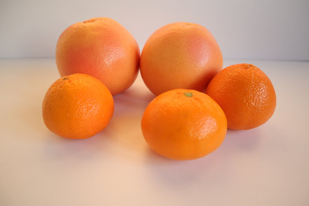 Orange and grapefruits on a white background, close-upの写真素材