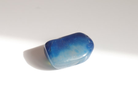 Blue jade gemstone on a white background. Macro photo.の写真素材