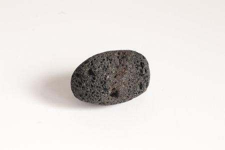 Lava Stone isolated on a white background. Macro photography. Top view.の写真素材