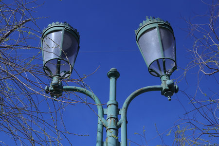 Vintage street lamp against the blue sky, closeup of photoの写真素材