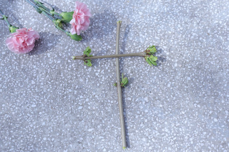 Cross and flower on cement floor,Vintage color tone style.の写真素材