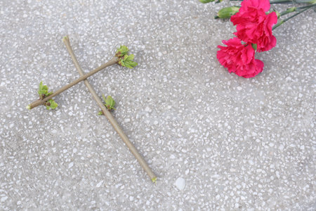 Carnation and cross on cement floor, Memorial Day concept.の写真素材