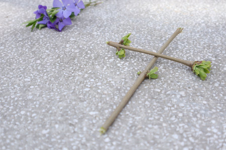 Cross and flower on the cement floor in the Christian cemetery.の写真素材