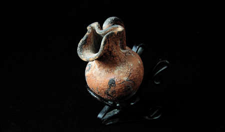 Old ceramic pitcher, for wine and water on a black backgroundの写真素材