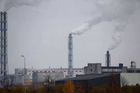 Factory with smoking chimneys in cloudy, Lithuania, Kedainiaiの写真素材