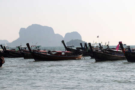 Thai traditional longtail boat tour big diesel engine. Boat sea and sand in Thailandのeditorial素材