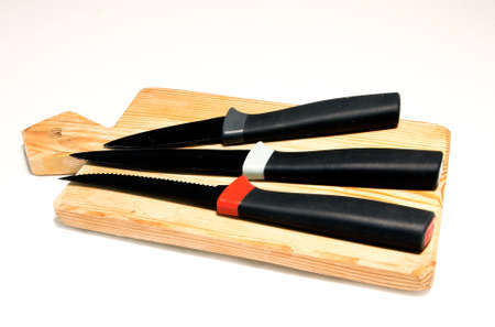 Empty chopping board with a sharp paring knife on white background