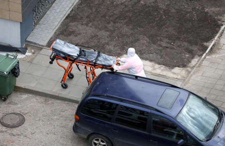 An ambulance and medical staff provide first aid during a pandemic. Lithuania, Kaunasのeditorial素材