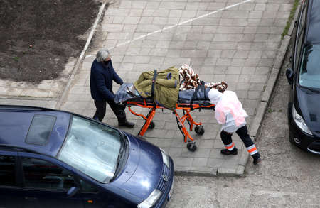 An ambulance and medical staff provide first aid during a pandemic. Lithuania, Kaunasのeditorial素材
