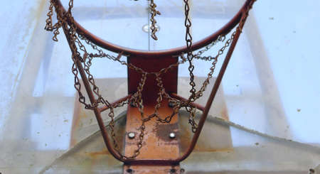 Outdoor Basketball Hoop in evening time.   Outdoor basketball hoop and board damaged. Nida Lithuania