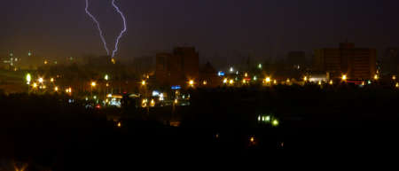 Lightning strikes down over the city at night. Long Exposure Photography. Lithuania Kaunas