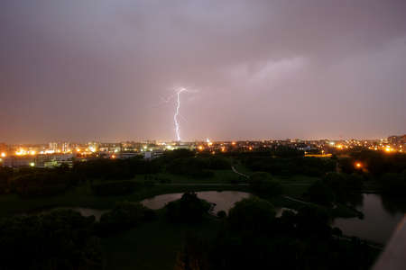 Lightning strikes down over the city at night. Long Exposure Photography. Lithuania Kaunas