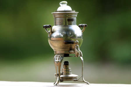 Antique Russian samovar on a wooden tableの写真素材