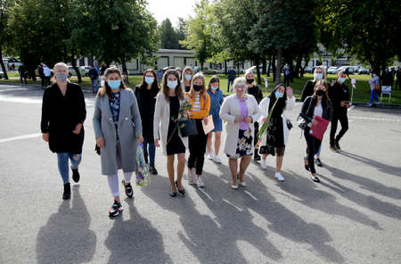 Pupils and teachers wearing masks protect themselves from coronavirus when they return to school....