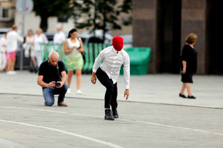 A solo dancer on the street. Protest dance, in the colors of the historical flag of Belarus, support...