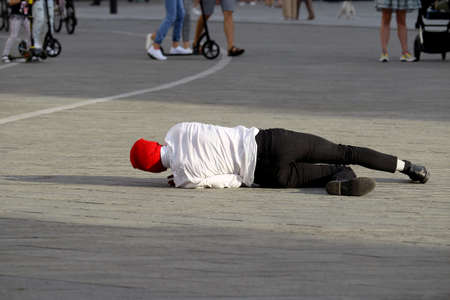 A solo dancer on the street. Protest dance, in the colors of the historical flag of Belarus, support for the protest in Belarus. Kaunas, Lithuania 23 08 2020のeditorial素材