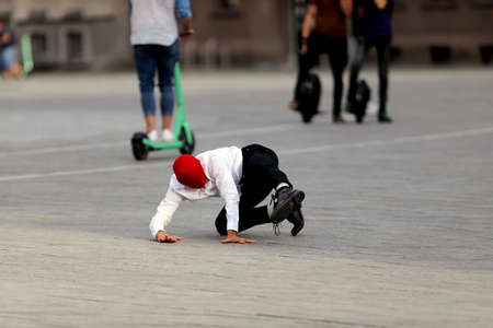 A solo dancer on the street. Protest dance, in the colors of the historical flag of Belarus, support for the protest in Belarus. Kaunas, Lithuania 23 08 2020のeditorial素材