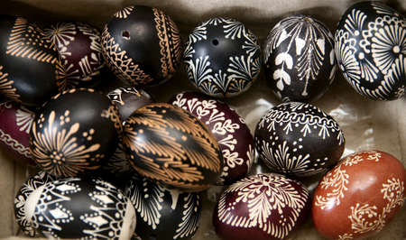 Colorful painted eggs in a nest of twigs of willow on a light background. Traditionally for Easter....