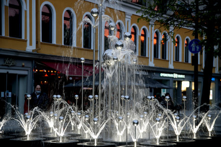 Colorful illuminated musical fountain in Kaunas at dusk, city center, Laisves alley. Lithuaniaの写真素材