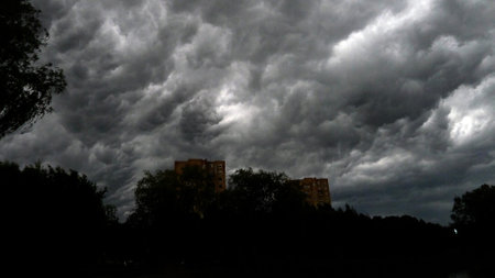Dramatic cumulonimbus stormy clouds over cityscape Kaunas, Lithuaniaの写真素材