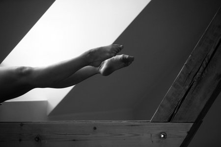 Woman's legs in the background of the windowの写真素材