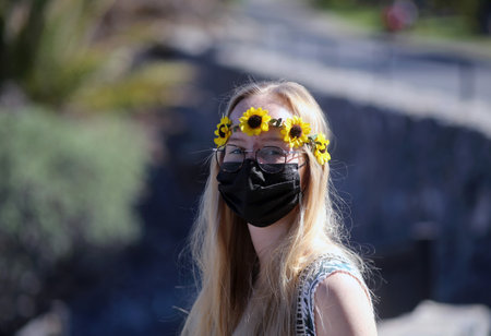 Attractive woman wearing a protective maskの写真素材