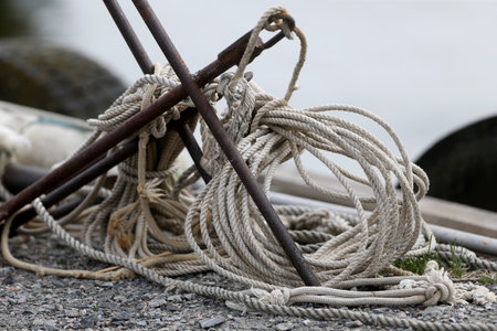 Pile of old worn hemp rope coils on boat deck background texture pattern.