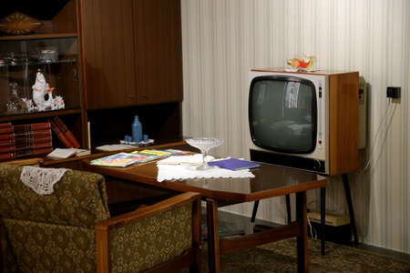 Retro TV with table and armchairs