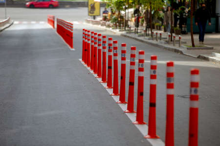 Red and white striped poles in the rowの写真素材