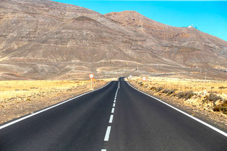 Beautiful road in the desert of Fuerteventura, Canary Islands at sunsetの写真素材