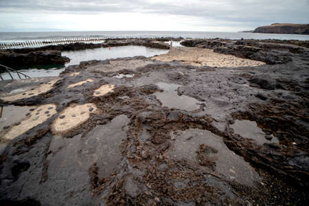 View of Natural sea pool Las Salinas de Agaete in Puerto de Las Nieves and coast cliffs. Gran...