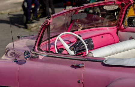Retro car details on a city street. American cars in Cuba