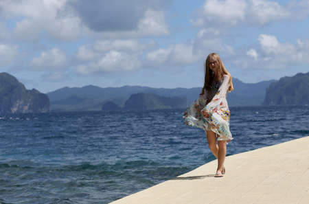 Beautiful girl jumping in tropical sea