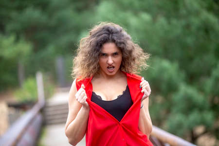 Portrait of a young angry screaming woman, outdoorsの写真素材
