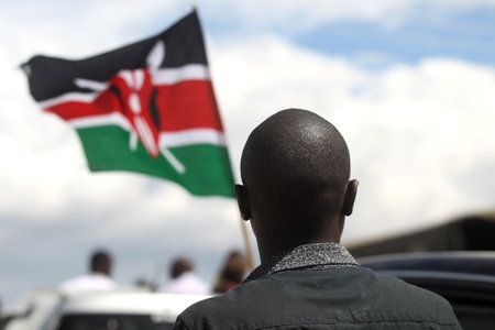 A man's head and a Kenyan flag flying in the sky backgroundのeditorial素材